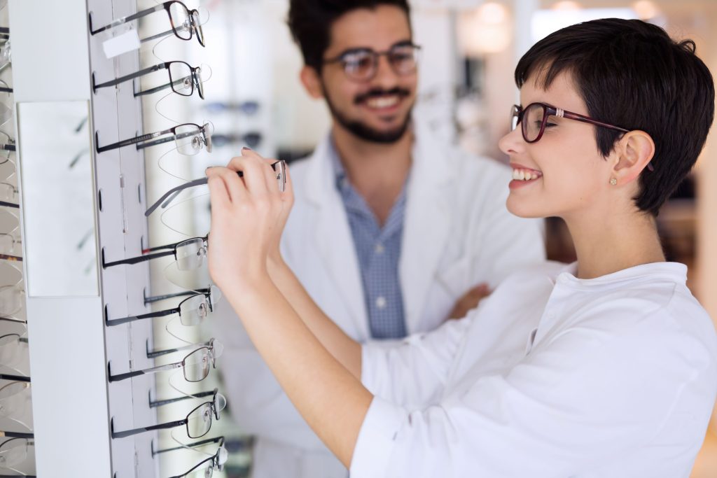 beautiful woman with optician trying eyeglasses 2021 08 27 09 38 55 utc scaled